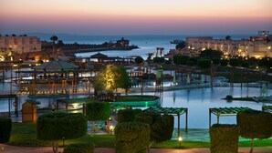 A resort with a marina, a pool, and a view of the sea at dusk. - SUNRISE Crystal Bay Resort - Posh Club (Hurghada)