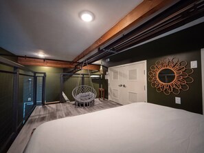 A bedroom with a hanging chair, a bed, a wardrobe, and a decorative mirror. - ⁂Pet Friendly⁂10min-Airport⁂AC⁂Gym⁂2Bed (Santa Ana)
