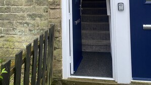 A staircase leading to a blue door with the number 17, adjacent to a white door with the number 3.