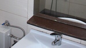 A bathroom with a white sink, a mirror, and a shower. - Remarkable 1-bed Apartment in Thessaloniki (Thessaloniki)