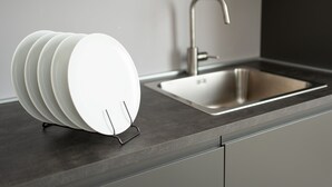 A modern kitchen with a built-in sink and a white plate rack. - Lake Design Guest House | Come Center (Como)