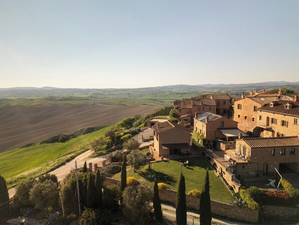 A rural village with traditional architecture, terraced fields, and a clear view of the surrounding landscape.