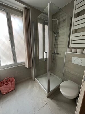 Een douche, een haardroger, handdoeken, toiletpapier