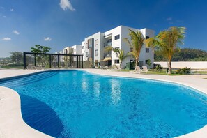 A swimming pool with a modern building in the background.