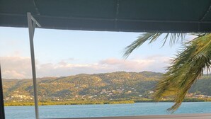 A balcony with a view of a lake and hills. - The perfect tropical getaway for couples, families and friends! (Montego Bay)