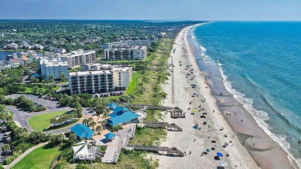 A coastal hotel with multiple buildings, a beach, and a boardwalk. - Spacious 4 Bedroom, 3 Bath Condo in Pawleys Island: 2-minute drive to pvt beach (Pawleys Island)
