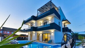 A modern two-story house with a swimming pool, outdoor seating, and a pergola. - Holiday Home in Bibinje with Seaview, Balcony, Air condition, WIFI (5201-1) (Bibinje)