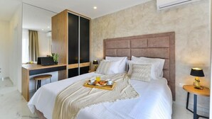 A modern hotel room with a large bed, a desk, and a wardrobe. - Holiday Home in Bibinje with Seaview, Balcony, Air condition, WIFI (5201-1) (Bibinje)