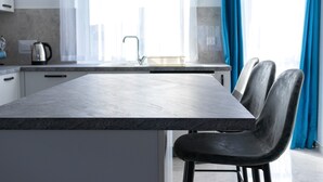 A modern kitchen with a marble countertop, a kettle, and a sink. - Seaside Serenity - Luxe Penthouse - near the beach (Il-Mellieha)