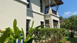 A two-story building with a flat roof and a balcony on the second floor. - Poolside Luxury Laguna 2-bed Villa in Cherngtalay (Choeng Thale)