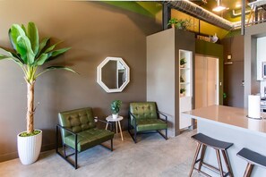 A modern interior with a bar area, seating, and a large potted plant.