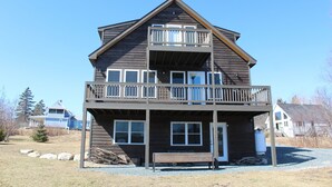 A two-story wooden building with a balcony on the upper floor.