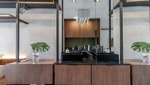 A modern bathroom with a large mirror, dual sinks, and wooden cabinetry. - Beurban 107 in S o Paulo (São Paulo)