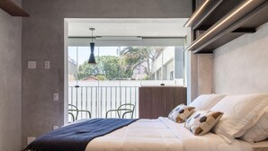 A bedroom with a bed, a window, and a view of the outside. - Beurban 107 in S o Paulo (São Paulo)