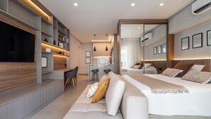A modern hotel room with a large bed, a sofa, a desk, and a TV. - Landingcb 1301 in S o Paulo (São Paulo)