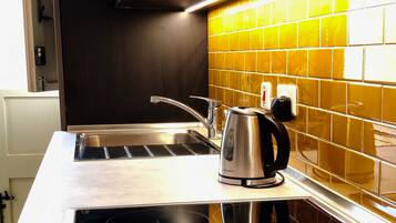 Estúdio standard, vista para o pátio, no piso térreo | Cozinha privada | Geladeira grande, micro-ondas, fogão, cooktop