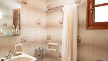 A bathroom with a sink, bathtub, and toilet.