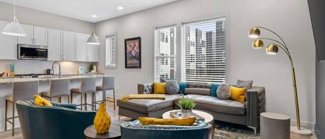 A modern living room with a sofa, chairs, and a coffee table.