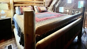 A wooden-framed loft bedroom with a bed, a nightstand, and a window. - New Hot Tub & Trailer Parking @ Cliff Eagle (Stanton)