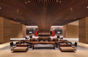 A modern lobby with a unique wooden ceiling design, a central seating area, and a red accent wall. - Le Mã©ridien Hualien Resort (Hualien City)
