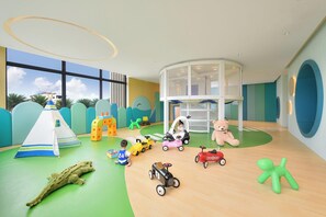 A children's play area with various toys, a playhouse, and a large window providing a view of the outdoors. - Le Mã©ridien Hualien Resort (Hualien City)