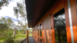 A wooden building with large windows and a covered porch. - Stawell Grampians Gate C & C Park (Stawell)