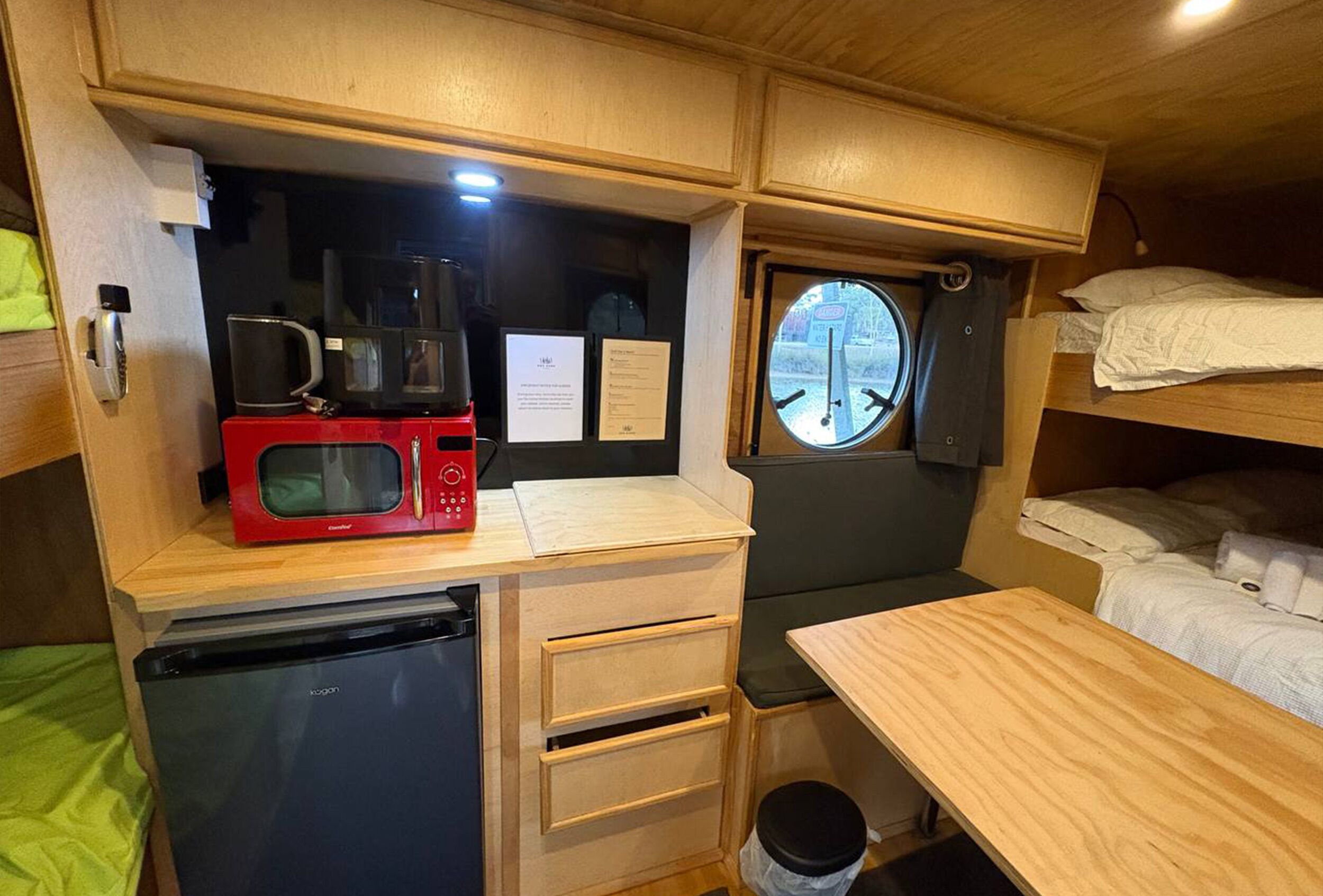 A compact kitchenette with a microwave, coffee maker, and a small refrigerator.