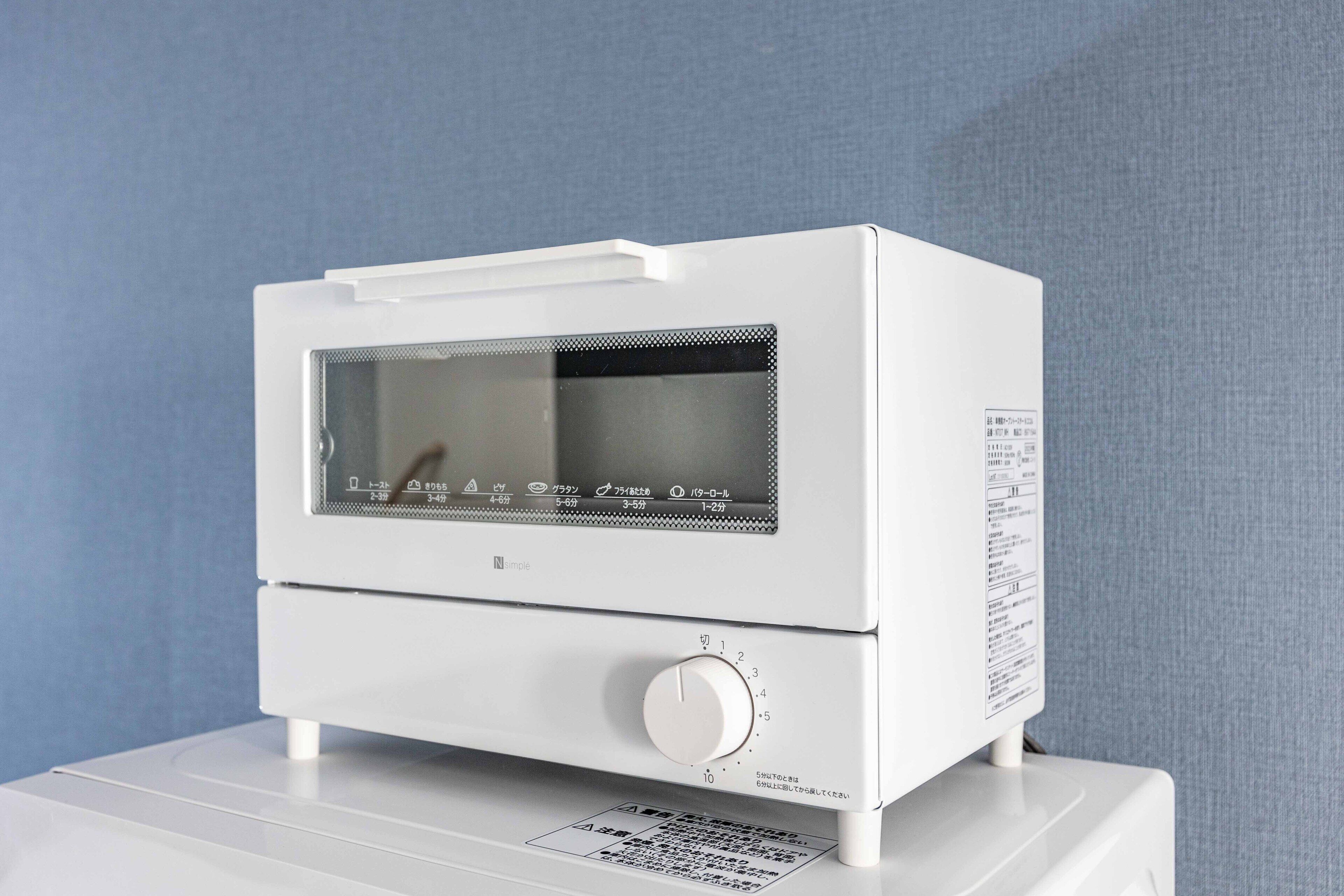 A white microwave oven with a digital display and a control knob.