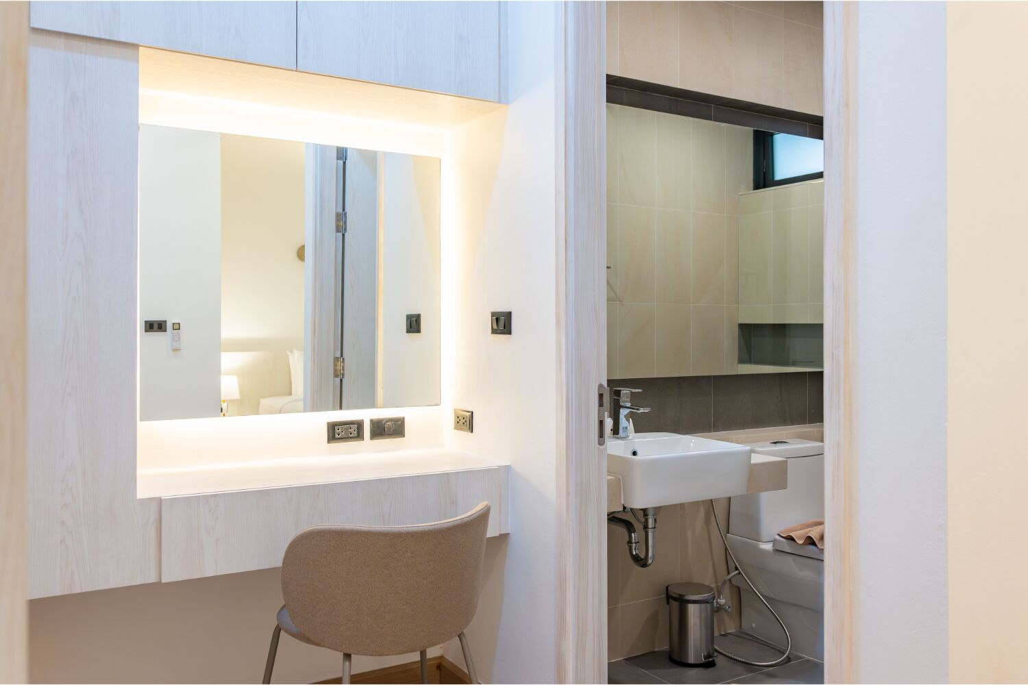 A modern bathroom with a vanity, mirror, and dual sinks.
