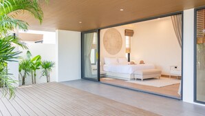 A modern bedroom with a large bed, a glass door leading to a balcony, and a view of the outdoors. - Villa Close to Fisherman Village - KBR15 (Koh Samui)