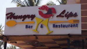 A sign for 'Hungry Lips Bar & Restaurant' with a stylized design including a fork and a spoon. - Hotel Shell Top  (Panaji)