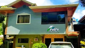 A two-story building with a sign reading "Feli's Guest House." - Felli's Guest House  (Tagbilaran)