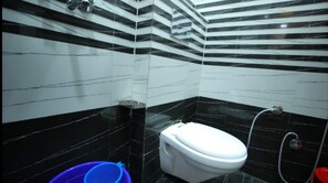 Standard Shared Dormitory | Bathroom | Rainfall showerhead, towels - Hotel Rajani (Bareilly)