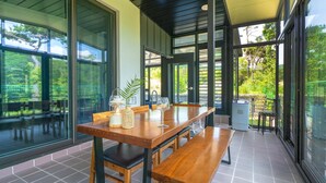 A spacious dining area with a long wooden table, benches, and large windows offering views of the outdoors. - Gyeongju Blibli Poolvilla (Gyeongju)