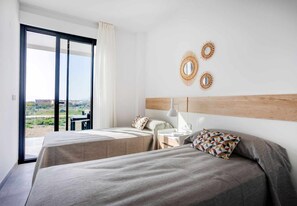 Ein Hotelzimmer mit zwei Betten, einem großen Fenster mit Ausblick und Wanddekoration.