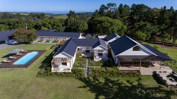 A large property with multiple buildings, a swimming pool, and a well-maintained garden.