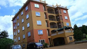 A multi-story hotel with balconies and a covered entrance. - GLORY SUMMIT HOTEL  (Hoima)