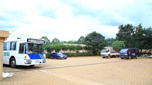 A parking area with a bus labeled "MANDELA S.S. ROYA" and several other vehicles. - GLORY SUMMIT HOTEL  (Hoima)