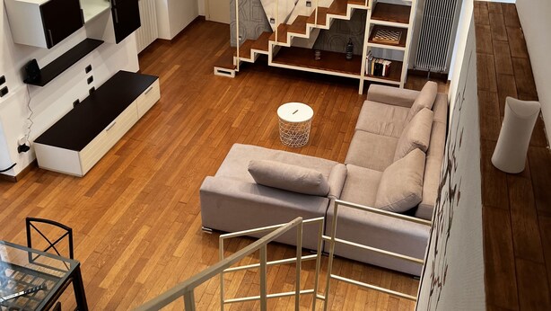 A modern interior with a staircase, a sofa, and a dining area. - Loft in downtown Milan, cozy, quiet 15 minutes from p.zza Duomo. (Milano)