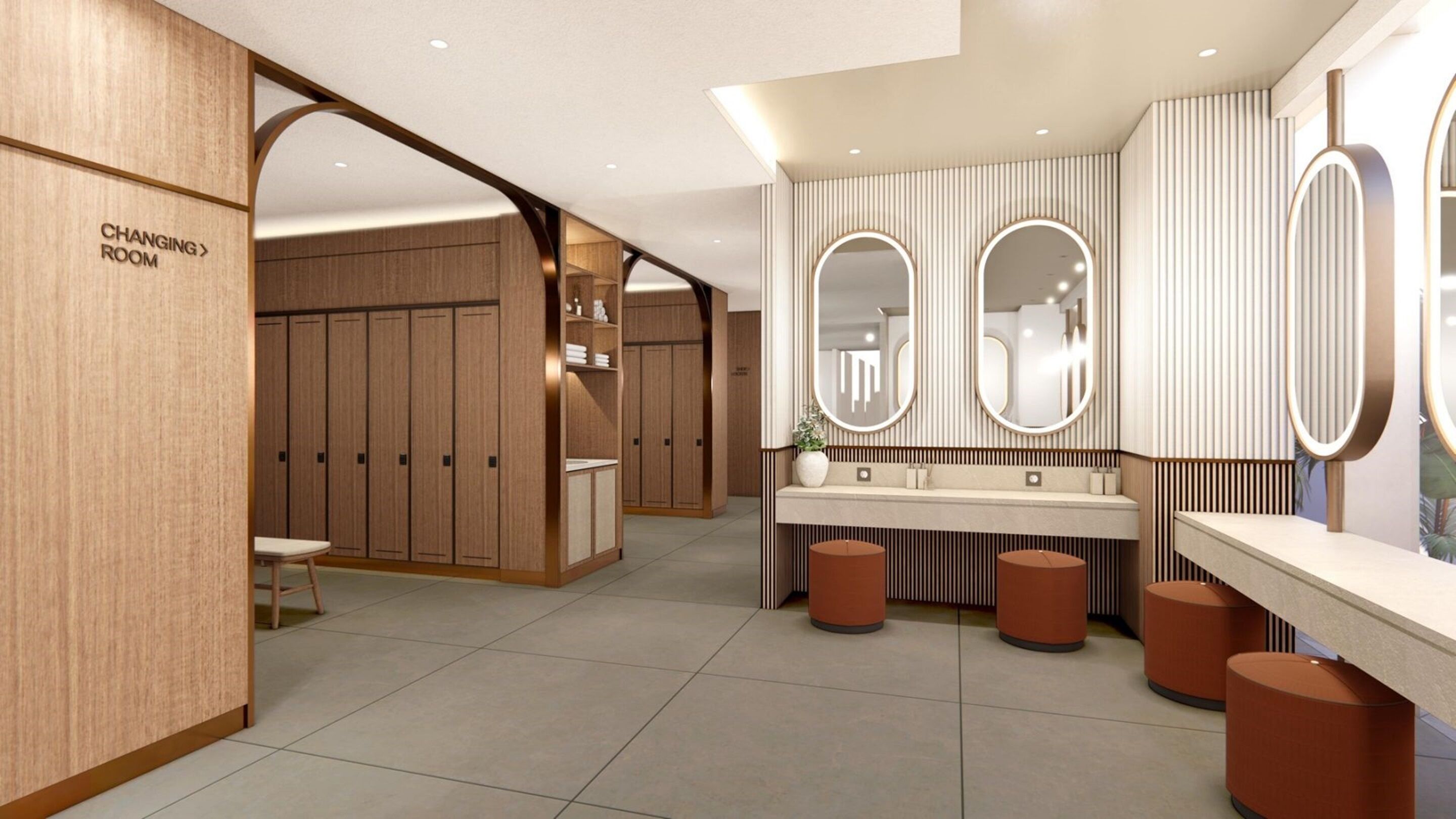 A modern bathroom with a vanity, two mirrors, and a changing room.
