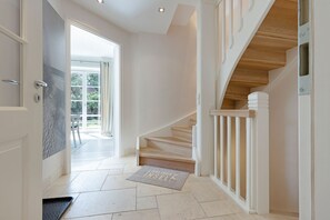 Stunning staircase leads to a bright, airy space with a warm welcome.