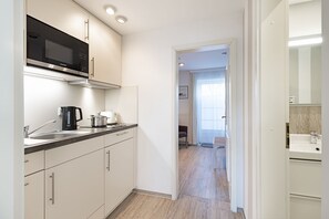 Fridge, stovetop, dishwasher, coffee/tea maker