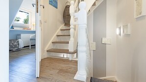 A staircase with white balusters and wooden steps leading to a landing.