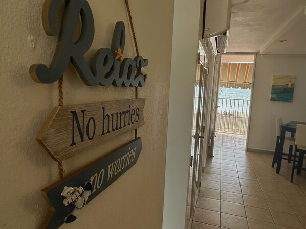 A hallway with a sign that reads "Relax No worries."