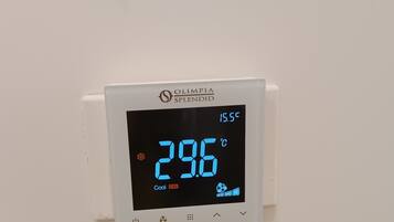 A digital thermostat displaying 29.6°C with 'Cool' and 'ON' indicators.