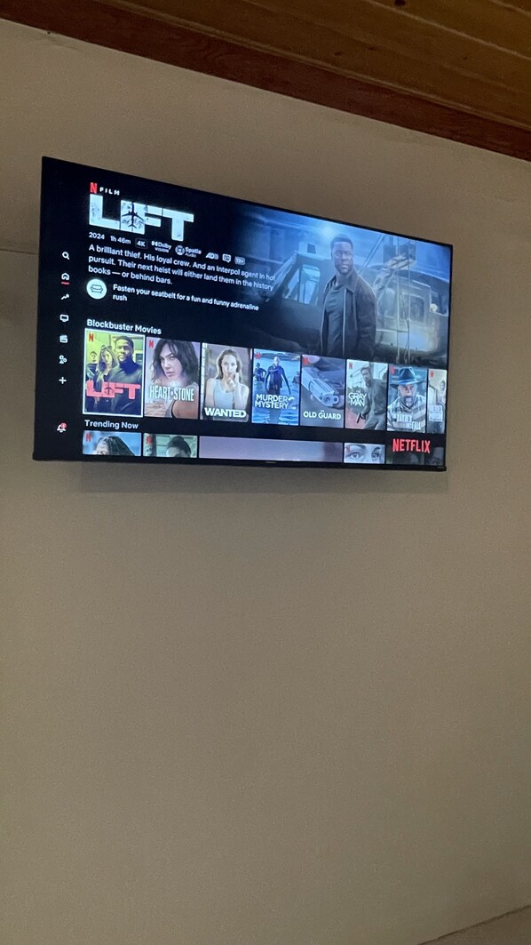 A television displaying a streaming service interface with various movie options. - Bahamas Beach Bliss: Pool, Yard & Paradise Awaits! (Nassau)