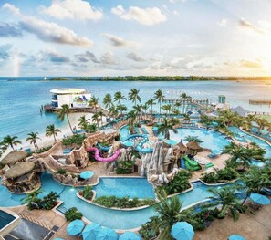 A resort with multiple swimming pools, water slides, and a beach area. - Bahamas Beach Bliss: Pool, Yard & Paradise Awaits! (Nassau)