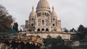A large, ornate building with multiple domes and a central statue. - Charming Apartment in Montmartre (Paris)