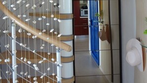 A spiral staircase with wooden steps and a netted wall. - Villa Lindos Star in Rodos with pool (Rhodes)