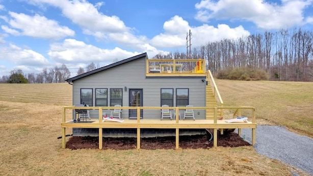 A single-story house with a covered porch and a small upper deck.
